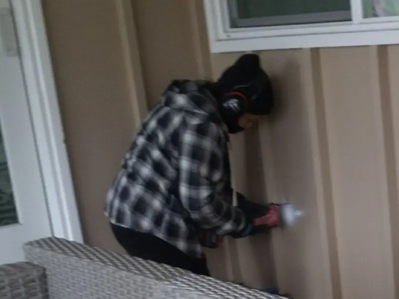 Professional electrician installing an exterior outlet in Logan